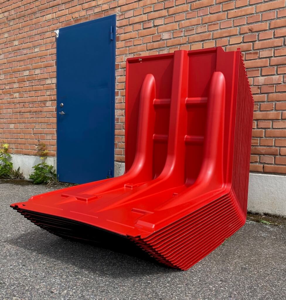 red noaq boxwalls stacked up on some tarmac 